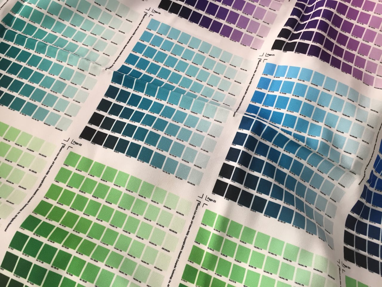 A colorful grid of fabric swatches showcasing a variety of vibrant colors and geometric patterns.